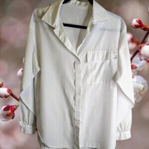 Woman's white button down front polyester front pocket blouse.
